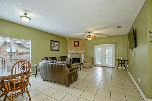 1210 Montgomery Blvd, Slidell, LA 70461 - living area featuring a textured ceiling, a ceiling fan, light tile patterned flooring, and a fireplace