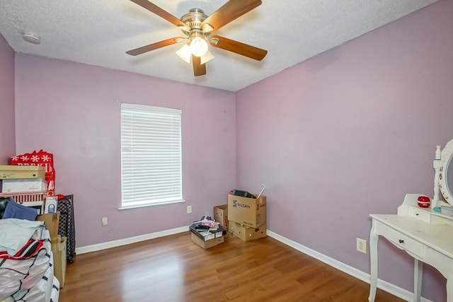 1210 Montgomery Blvd, Slidell, LA 70461 - bedroom with wood finished floors, a ceiling fan, and a textured ceiling
