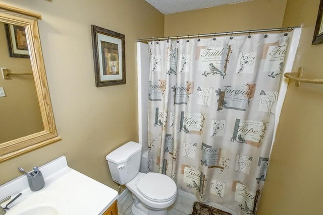 bathroom featuring tile patterned flooring, vanity, a textured ceiling, and toilet