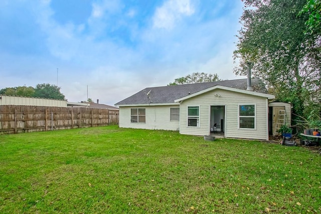 rear view of property featuring a yard