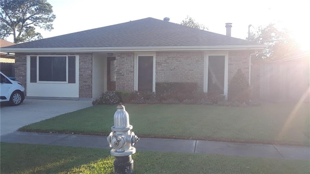 ranch-style house with a front lawn