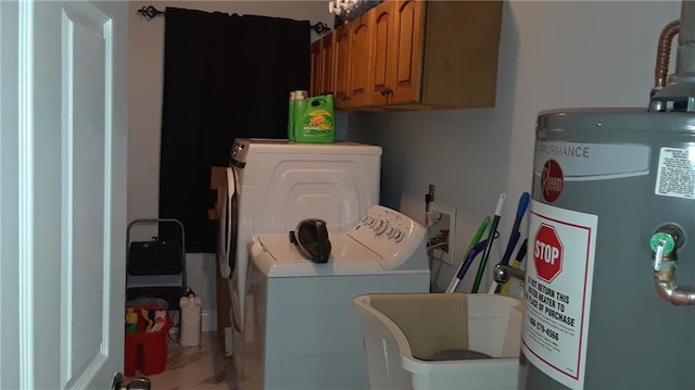 washroom with cabinets, separate washer and dryer, and water heater