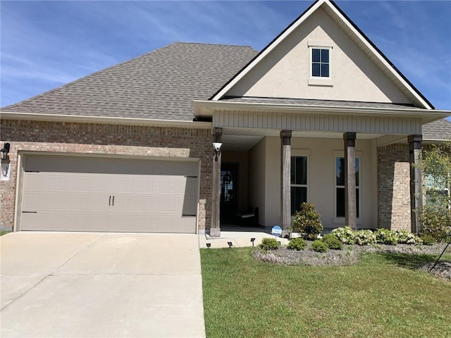 view of front of house featuring a porch, a garage, and a front yard