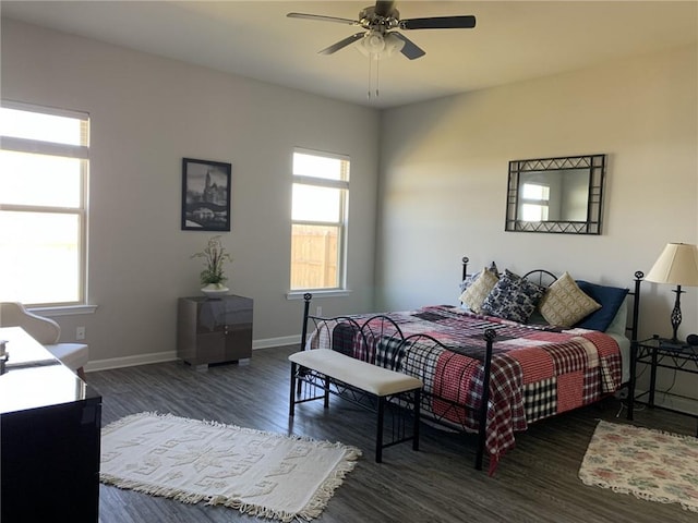 bedroom with dark hardwood / wood-style flooring, multiple windows, and ceiling fan