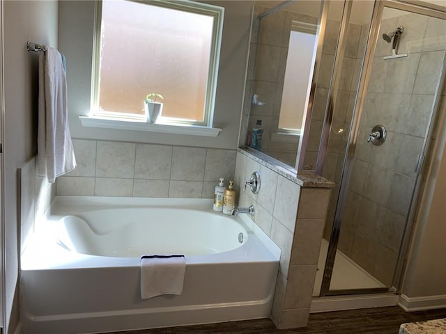 bathroom featuring shower with separate bathtub and hardwood / wood-style flooring