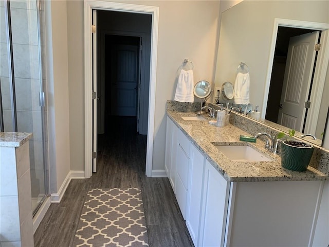 bathroom featuring hardwood / wood-style floors, vanity, and an enclosed shower