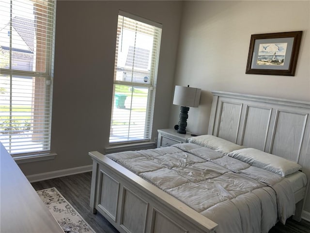 bedroom with dark wood-type flooring