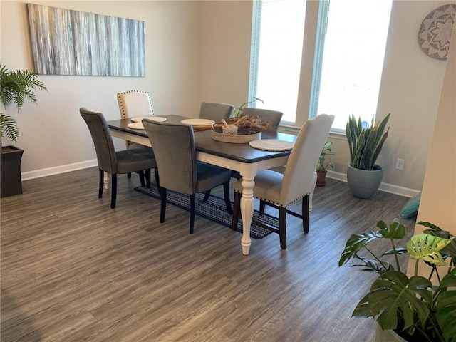 dining space with dark hardwood / wood-style flooring