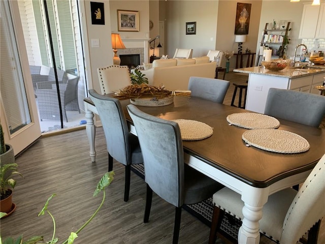 dining room featuring plenty of natural light, dark hardwood / wood-style floors, and sink