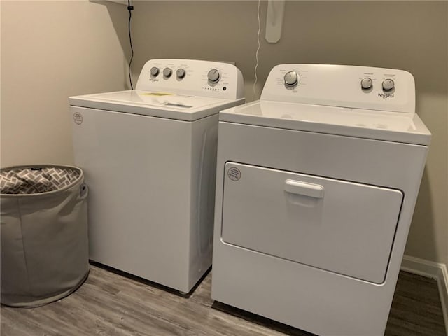 washroom featuring separate washer and dryer and light hardwood / wood-style floors