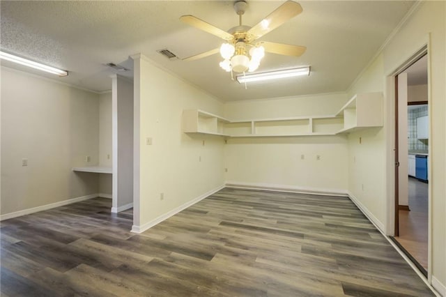 spacious closet with dark hardwood / wood-style flooring and ceiling fan