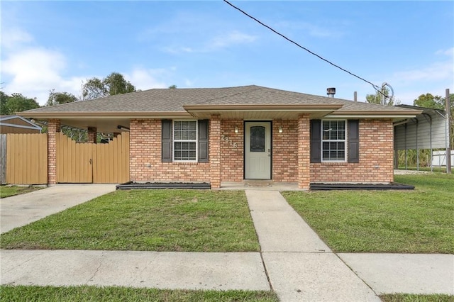 single story home featuring a carport and a front yard