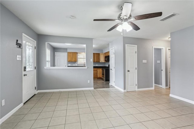 interior space featuring ceiling fan and light tile patterned flooring