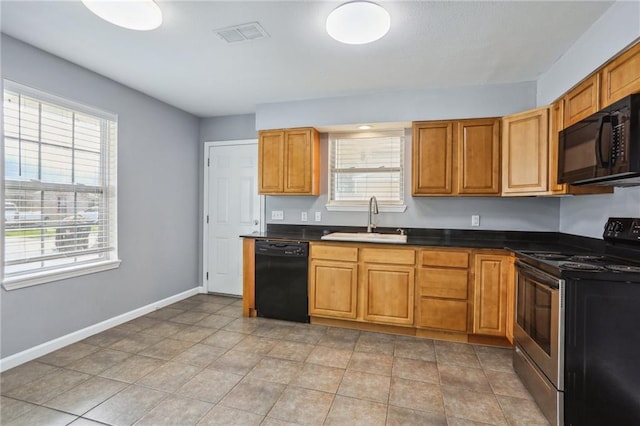 kitchen featuring light tile patterned floors, sink, and black appliances