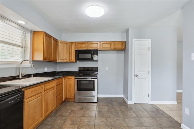 kitchen featuring tile patterned flooring, sink, and black appliances