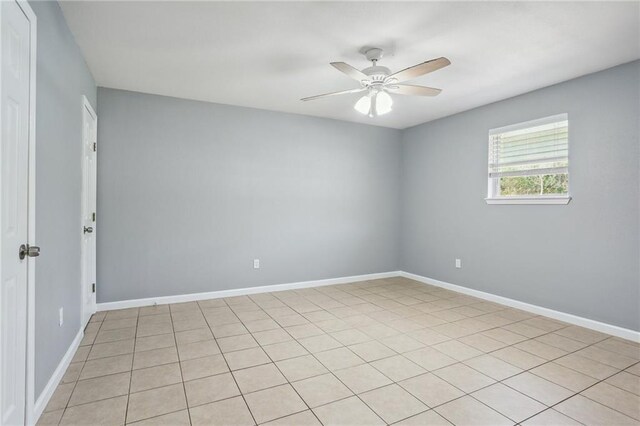 spare room featuring ceiling fan and light tile patterned flooring