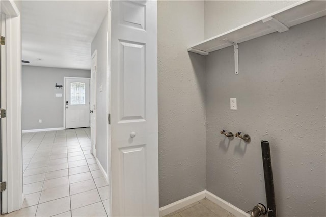 laundry room featuring washer hookup and light tile patterned flooring