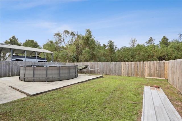 view of yard featuring a fenced in pool and a patio