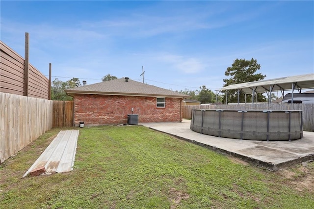 view of yard featuring a fenced in pool, cooling unit, and a patio area