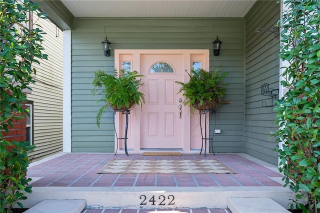 doorway to property featuring covered porch