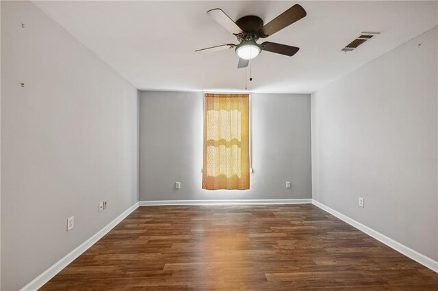 unfurnished room with ceiling fan and dark hardwood / wood-style flooring