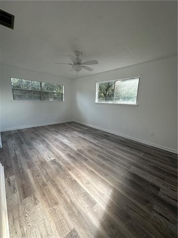 spare room featuring dark hardwood / wood-style floors and ceiling fan