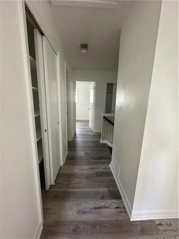 hallway with dark hardwood / wood-style flooring