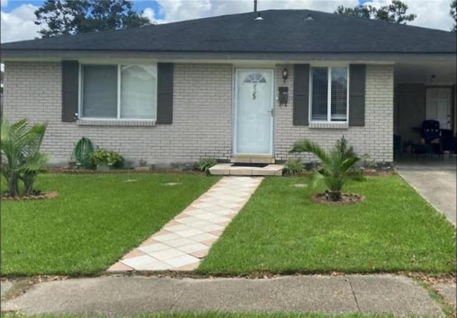 bungalow-style home with a front lawn