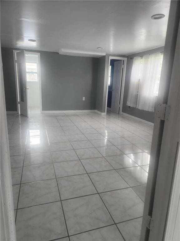 unfurnished room featuring light tile patterned floors