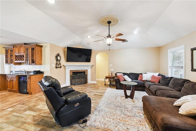 living room featuring ceiling fan, lofted ceiling, and beverage cooler