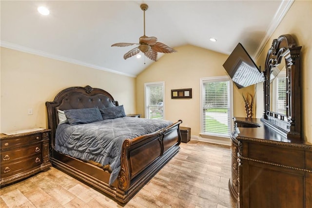 bedroom with vaulted ceiling, light hardwood / wood-style flooring, ceiling fan, and crown molding