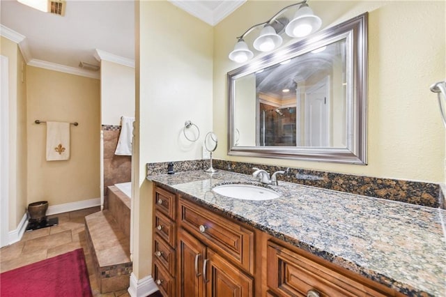 bathroom featuring tile patterned flooring, vanity, a bathtub, and ornamental molding