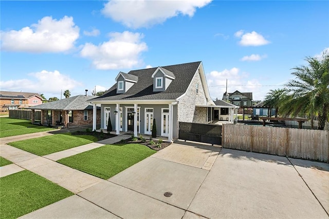 cape cod home with a porch and a front lawn