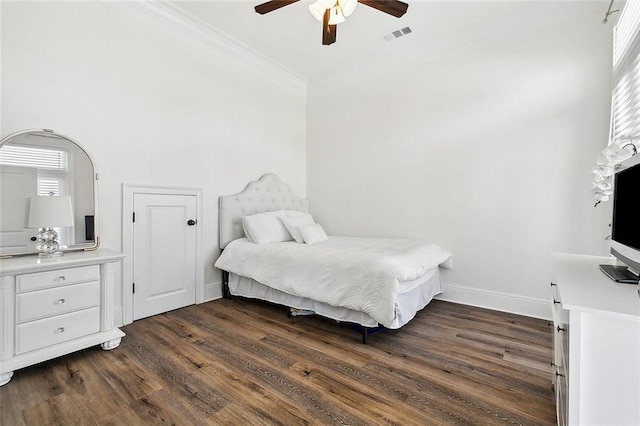 bedroom with ceiling fan, dark hardwood / wood-style flooring, and multiple windows