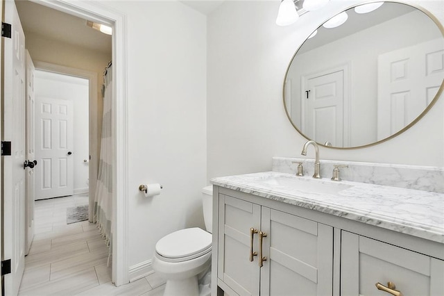 bathroom featuring vanity and toilet