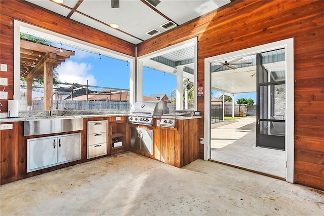 view of patio / terrace with grilling area, sink, and exterior kitchen