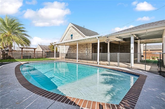 view of pool with ceiling fan and a patio