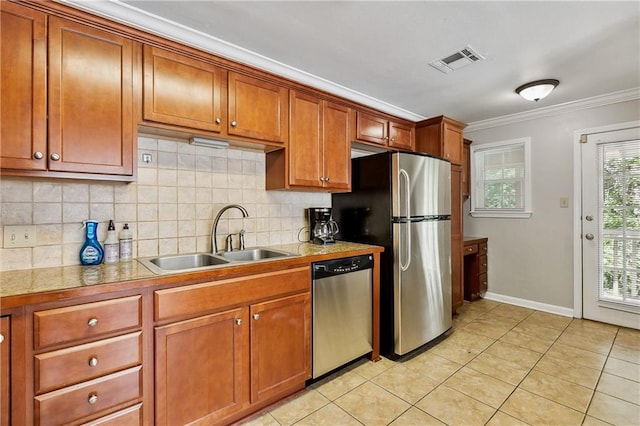 kitchen with sink, tasteful backsplash, crown molding, light tile patterned floors, and appliances with stainless steel finishes