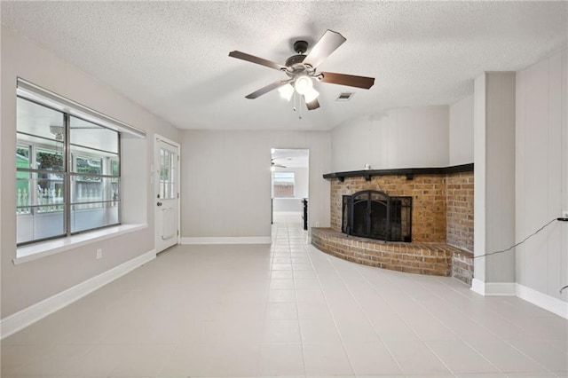 unfurnished living room with ceiling fan, a fireplace, and a textured ceiling