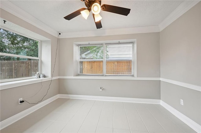 tiled spare room featuring ceiling fan, a textured ceiling, and ornamental molding