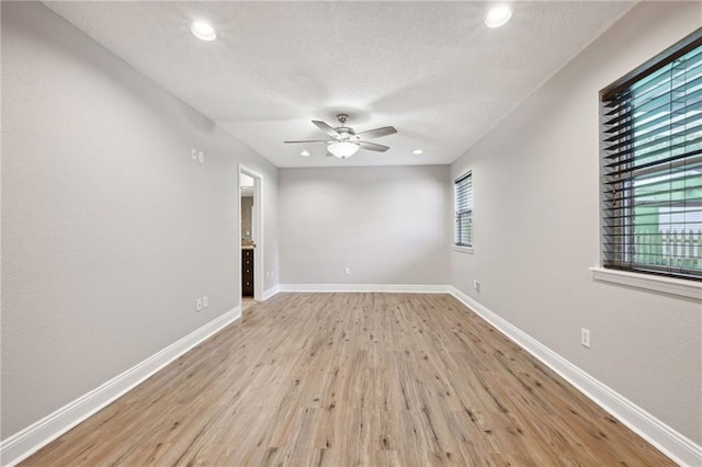 spare room featuring ceiling fan and light hardwood / wood-style flooring