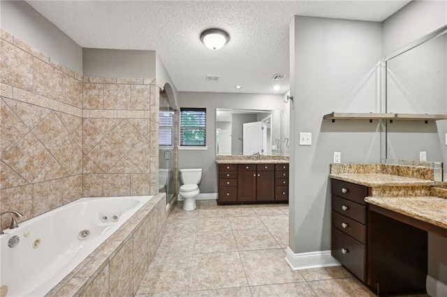 full bathroom with a textured ceiling, vanity, independent shower and bath, tile patterned flooring, and toilet