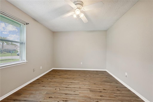 empty room featuring hardwood / wood-style flooring, ceiling fan, and a textured ceiling