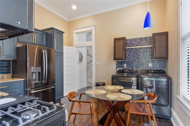 kitchen with tasteful backsplash, stainless steel appliances, crown molding, washer and dryer, and dark hardwood / wood-style floors