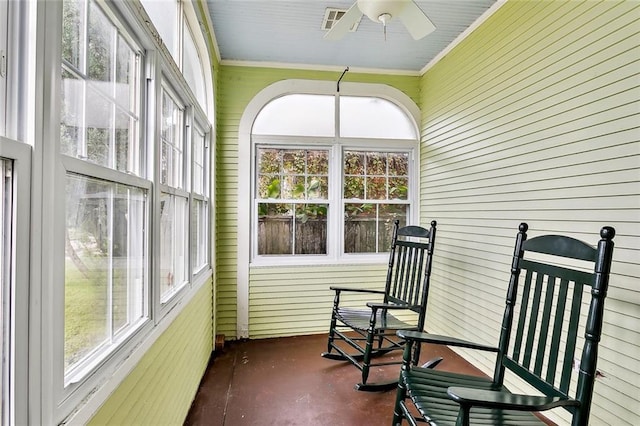 sunroom / solarium featuring plenty of natural light and ceiling fan