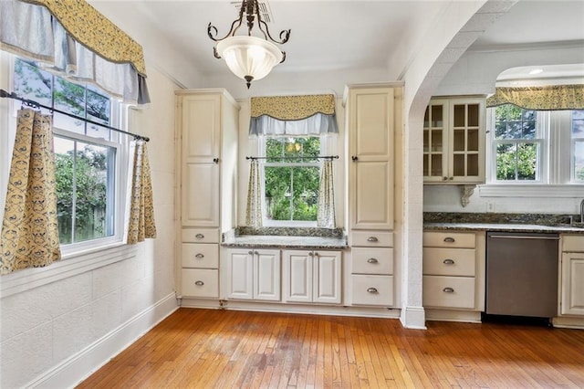 interior space featuring dishwasher, cream cabinetry, light hardwood / wood-style flooring, and hanging light fixtures