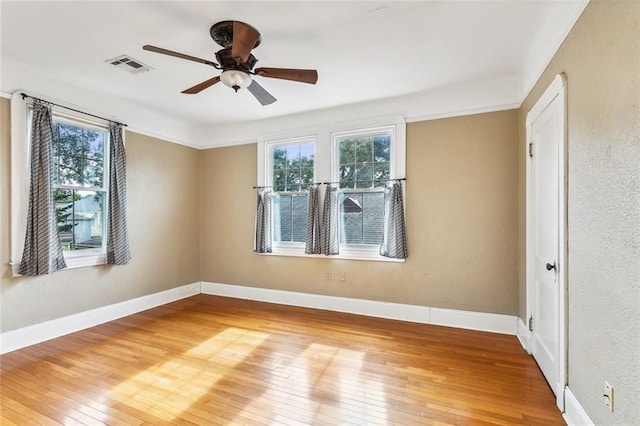 spare room with ceiling fan and hardwood / wood-style floors