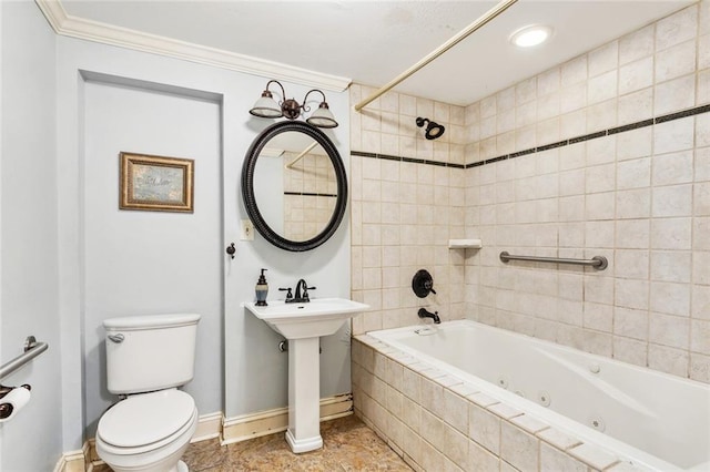 bathroom with crown molding, toilet, and tiled shower / bath