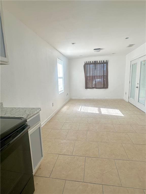 unfurnished living room with light tile patterned floors