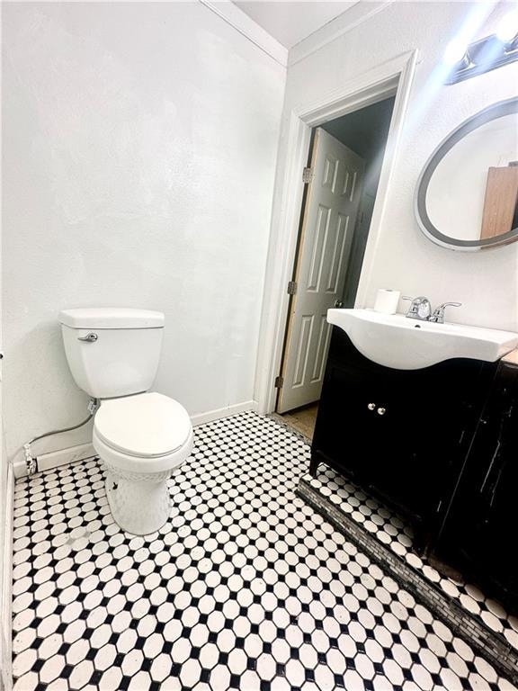 bathroom featuring crown molding, vanity, and toilet